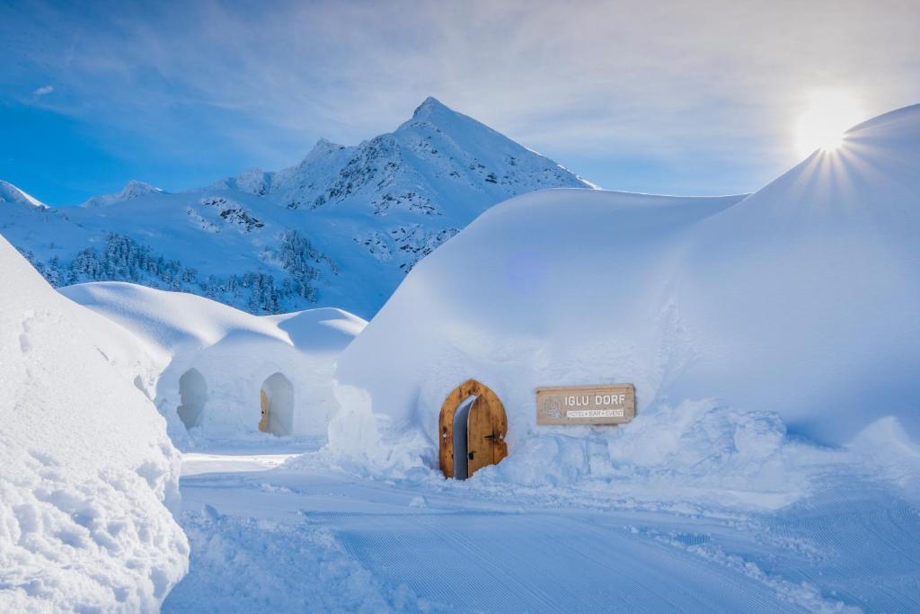 Linked snow domes on an alpine terrace above Gstaad